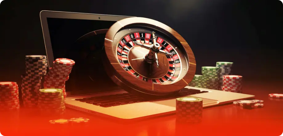 Roulette surrounded by chips and a laptop on the background